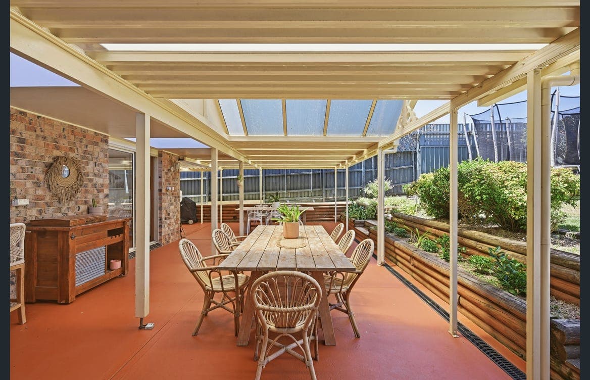 Covered outdoor dining for the whole group, rain or shine, at Watonga Coastal Retreat