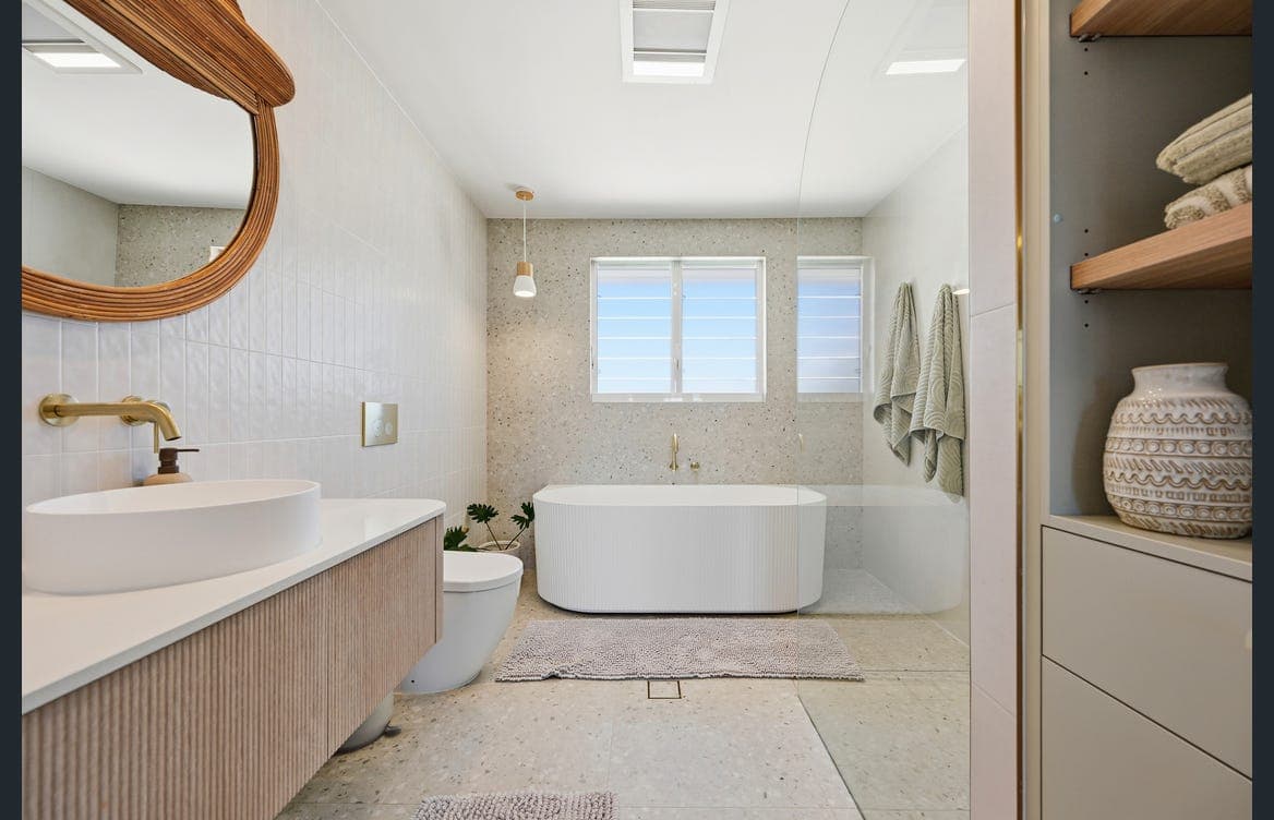Spa-style bathroom with a freestanding soaking tub and walk-in shower — a relaxing retreat after the beach